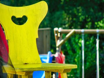 Close-up of yellow chair in park