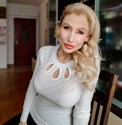 Portrait of beautiful woman sitting on chair at home