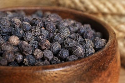 Close-up of black peppercorn in container