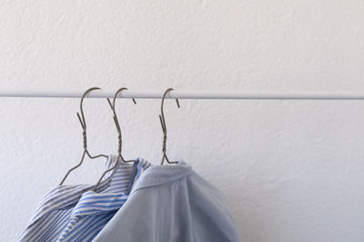 Clothes on hangers, blue shirts on a white background, shopping, clothes wardrobe