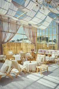 Empty chairs and tables in restaurant