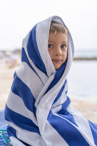 Portrait of young woman standing at beach