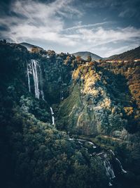 Scenic view of waterfall against sky