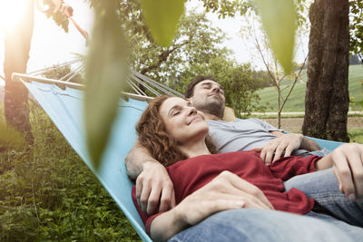 Couple relaxing in hammock