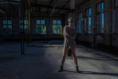 Portrait of man wearing dress while standing in abandoned house