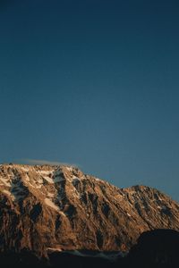 Scenic view of mountains against clear blue sky