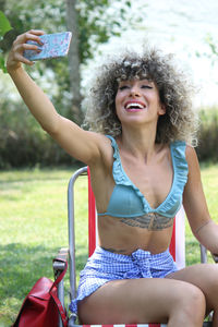 Young woman smiling while sitting outdoors