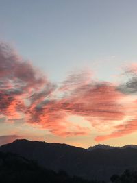 Low angle view of silhouette mountains against sky at sunset