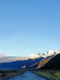 Scenic view of snowcapped mountains against blue sky