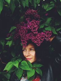 Portrait of woman holding plant