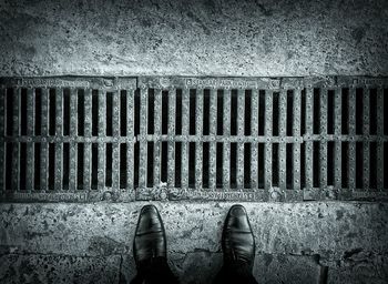 Low section of person standing on tiled floor
