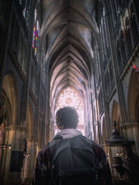 Rear view of man standing in temple against building