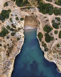 High angle view of river flowing through rocks