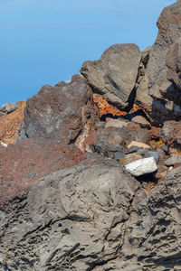 Rock formations on land against clear blue sky