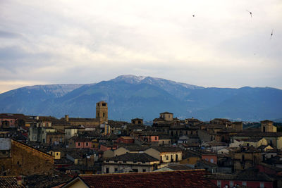 High angle view of town against cloudy sky