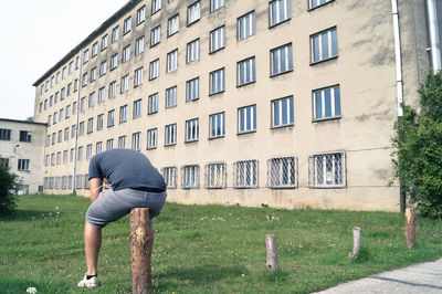 Full length of man climbing on wall