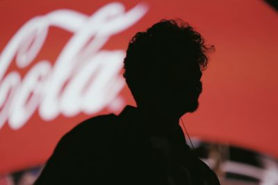 Close-up of silhouette man against red background