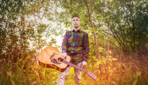 Portrait of young man playing guitar