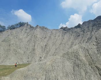 Panoramic view of people on land against sky