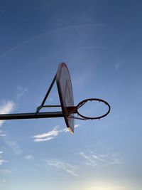 Low angle view of basketball hoop against blue sky