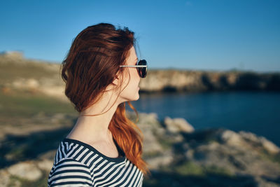 Portrait of beautiful woman against sky