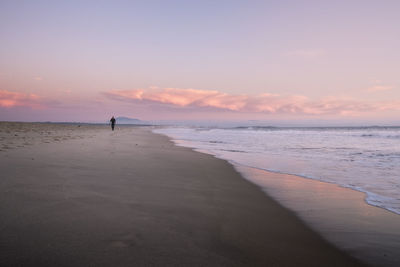 Scenic view of beach against sky during sunset