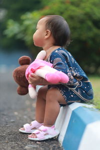 Portrait of girl playing with toy