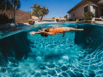 Girl floating under water in pool