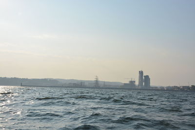 Scenic view of sea and buildings against sky