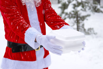 Midsection of woman holding gift