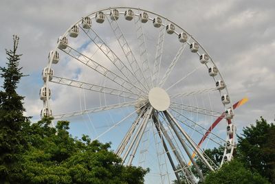 Low angle view of ferris wheel against sky