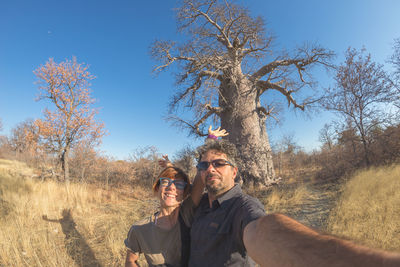 Portrait of young couple standing on field