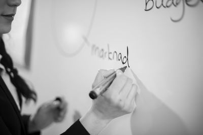 Businesswoman writing on whiteboard