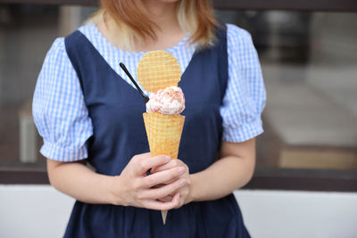 Midsection of woman holding food