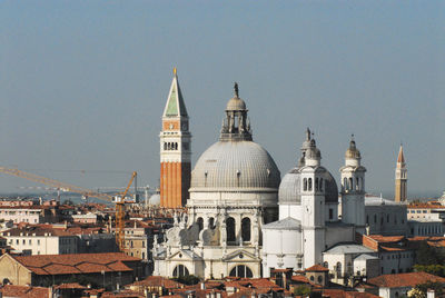 View of buildings in city against clear sky