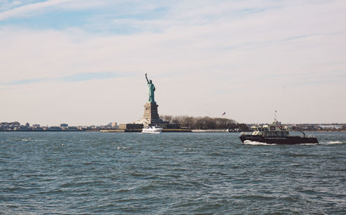 Statue of liberty by upper bay against sky