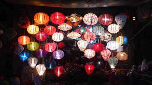 Illuminated lanterns hanging for sale at market