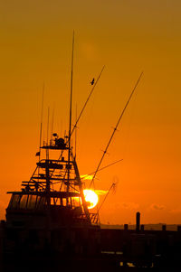 Silhouette sailboat against sky during sunset