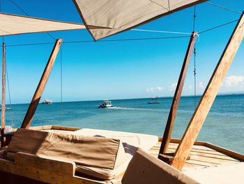 Sailboats on sea against clear sky