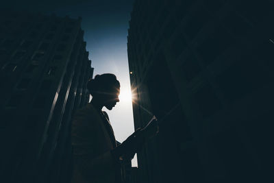 Side view of businesswoman standing in city