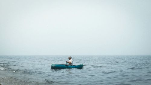 People sitting on boat in sea