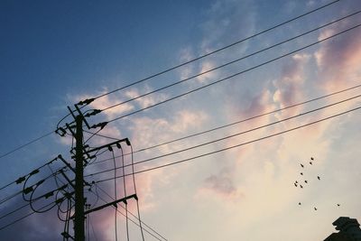 Low angle view of electricity pylon against sky