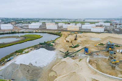 High angle view of buildings by sea against sky