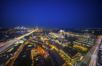 High angle view of illuminated city against sky at night