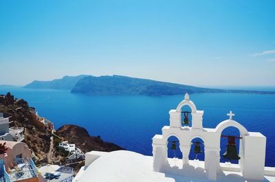 High angle view of bells at church by sea in santorini