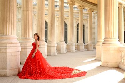 Woman in red dress standing indoors