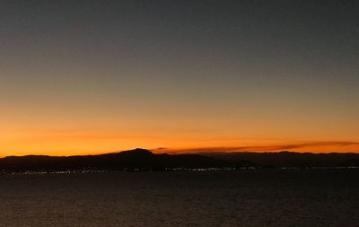 Scenic view of silhouette mountains against sky during sunset