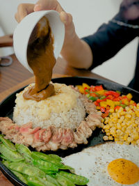Cropped hand of person holding food