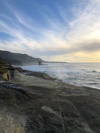 Scenic view of beach against sky during sunset