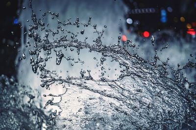 Close-up of water drops on car against sky